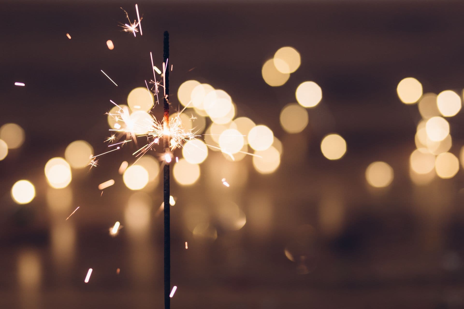 Golden sparks floating through a dark revenue intelligence backdrop